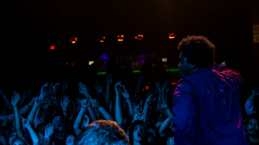 Blurred concert audience seen from behind