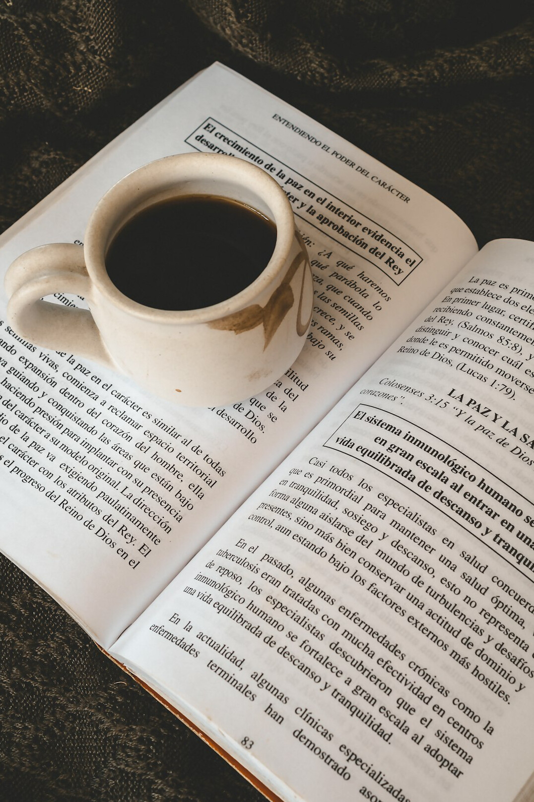 Open notebook with pen and coffee cup on a table