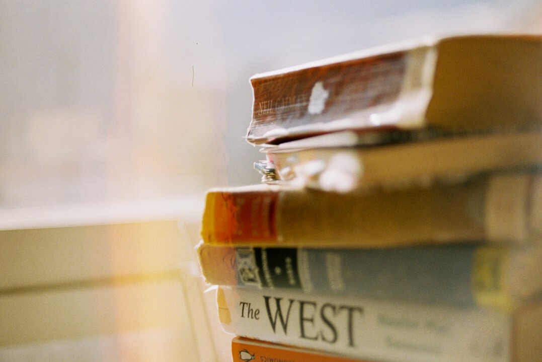 Stack of books on a table in warm light