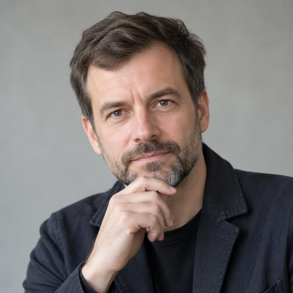 Portrait of a bearded man in a neutral setting