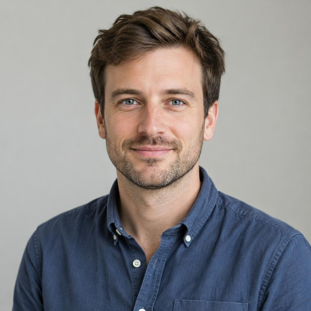 Portrait of a man with light stubble in a neutral setting